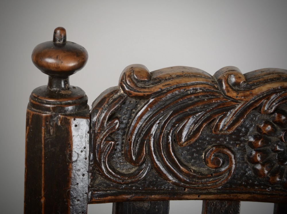A dark walnut Charles II style open armchair featuring intricate barley twist uprights, a carved floral cresting rail, a slatted timber lattice back, and turned stretchers. View XII