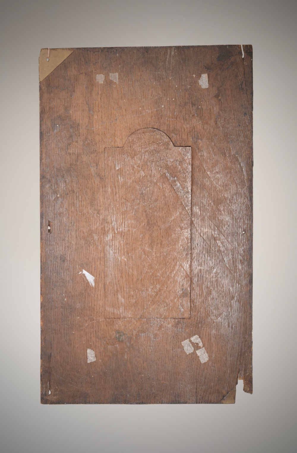 A dark brown rectangular carved oak panel depicting a central relief figure in armour framed by intricate strapwork and decorative scrollwork. View VI