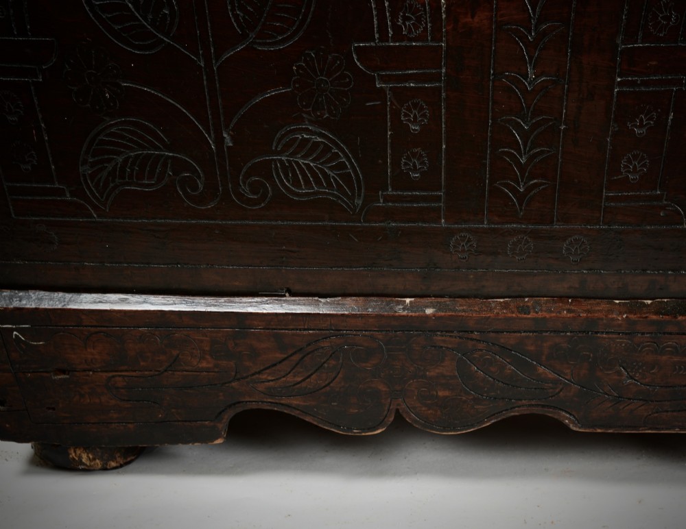 A dark brown 17th-century carved oak coffer featuring three carved arch panels, a central shield panel inscribed with the date 1644, and a shaped lower apron. View IV