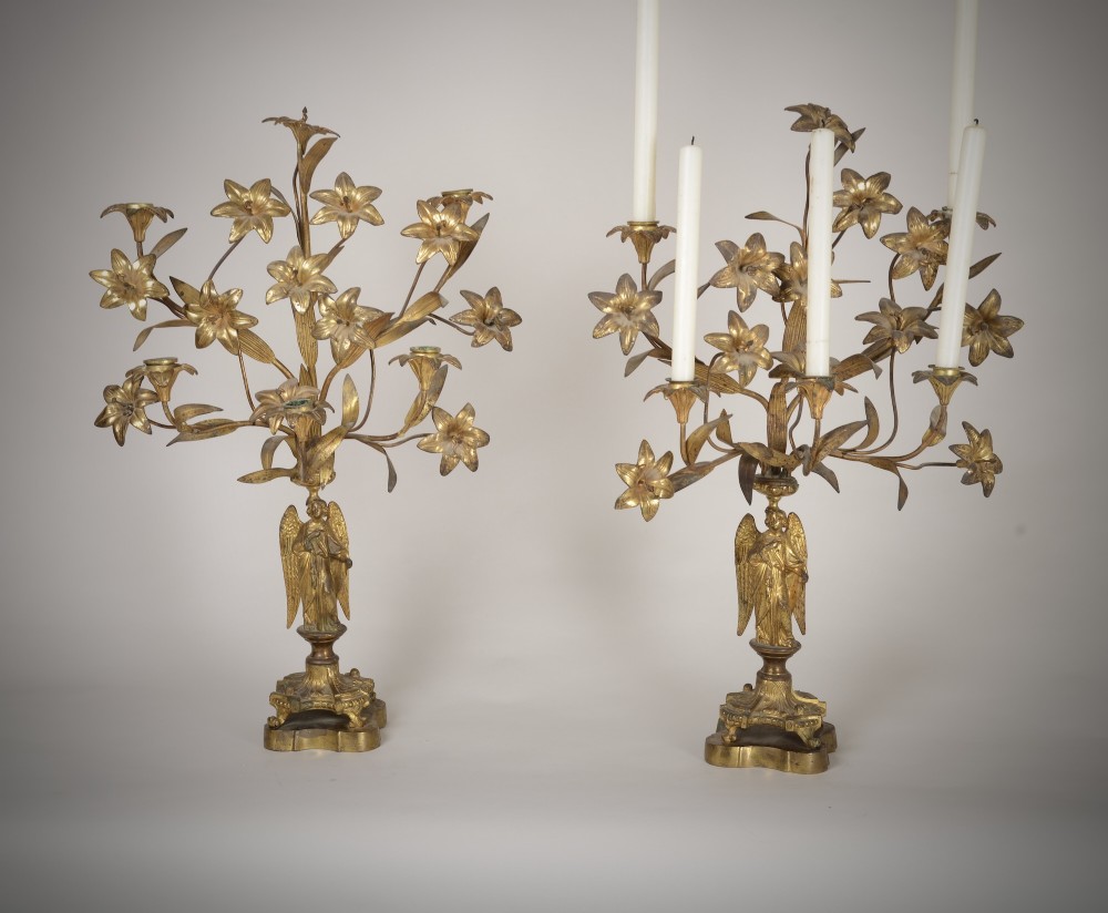 A pair of gilt brass Gothic Revival candelabra featuring sculpted angel pedestal bases and branching lily arms holding candles. View II
