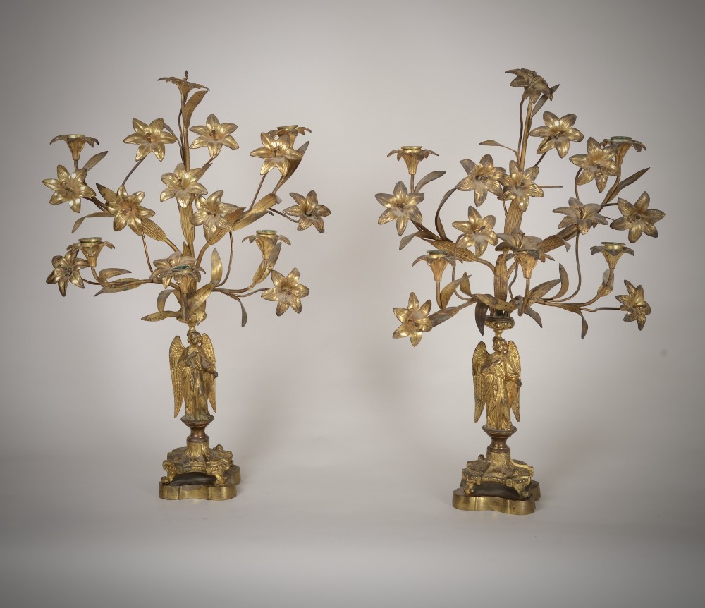 A pair of gilt brass Gothic Revival candelabra featuring sculpted angel pedestal bases and branching lily arms holding candles. View III