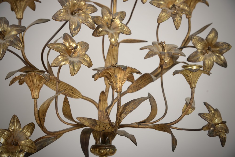 A pair of gilt brass Gothic Revival candelabra featuring sculpted angel pedestal bases and branching lily arms holding candles. View V