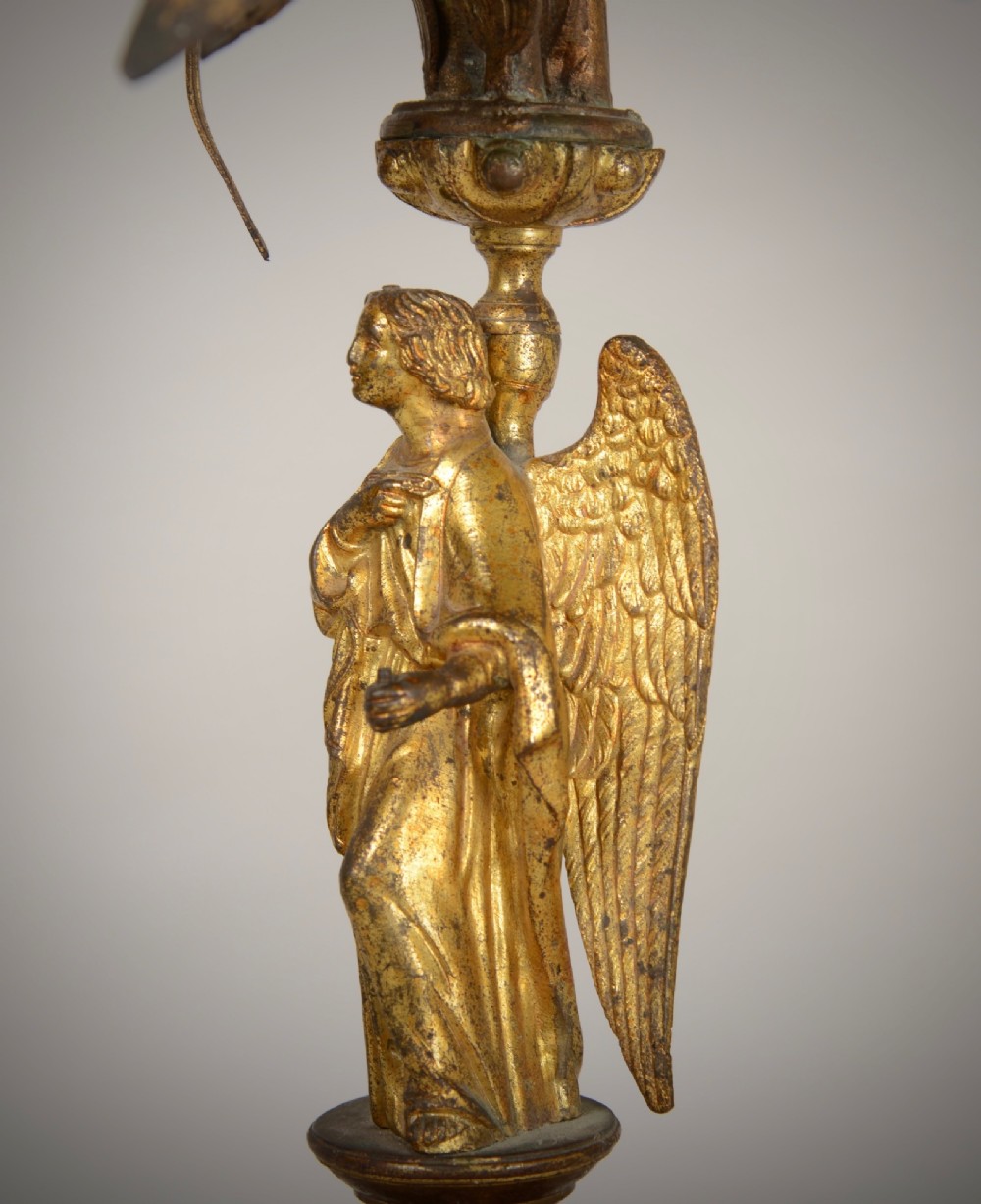 A pair of gilt brass Gothic Revival candelabra featuring sculpted angel pedestal bases and branching lily arms holding candles. View VII