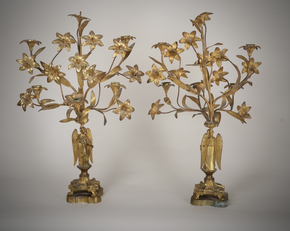 A pair of gilt brass Gothic Revival candelabra featuring sculpted angel pedestal bases and branching lily arms holding candles. View VIII