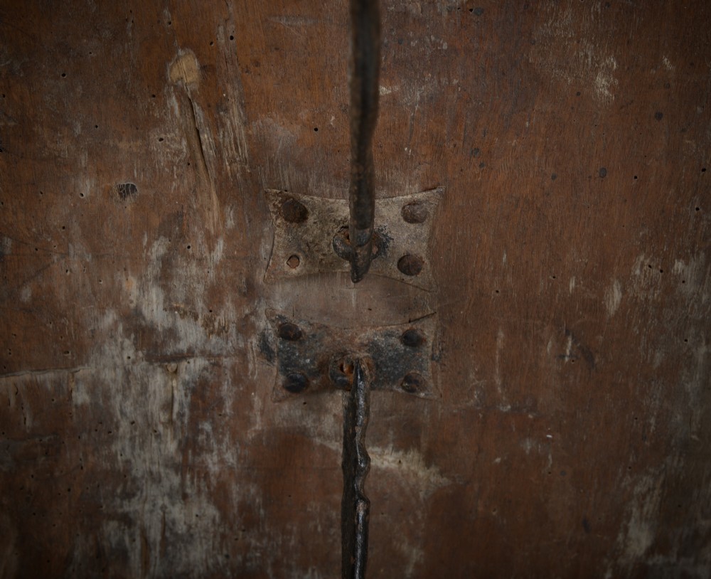 A Renaissance style carved wooden bench featuring two profile portrait roundels flanking a central cross on the backrest and wrought iron support stretchers beneath. View XI