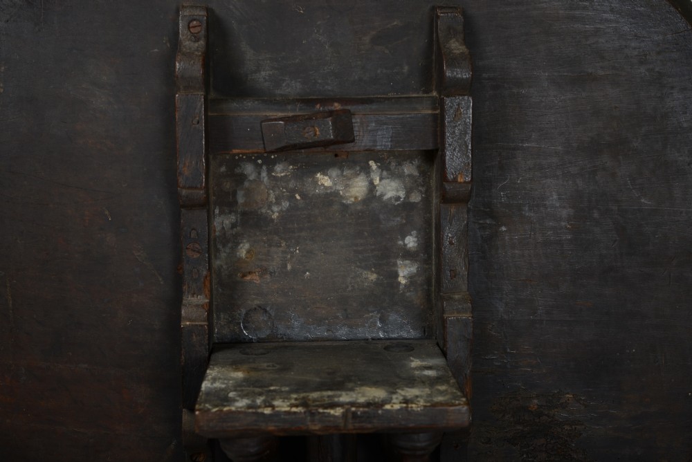 An antique dark brown oak tripod table featuring a circular top, a birdcage support mechanism, a turned central column, and three splayed feet. View IV