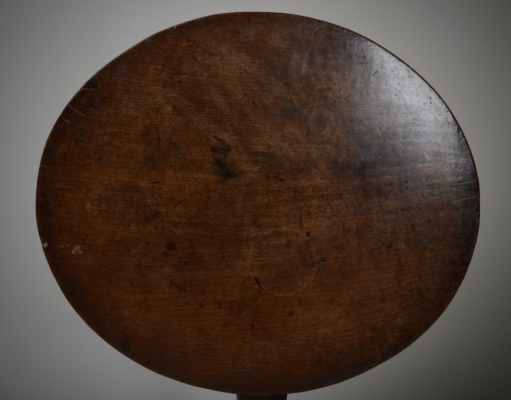 An antique dark brown oak tripod table featuring a circular top, a birdcage support mechanism, a turned central column, and three splayed feet. View VIII
