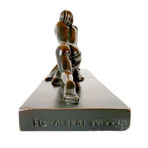 An Art Deco dark patinated bronze sculpture depicting a stylised female figure resting on an integrated rectangular bronze base. View IX