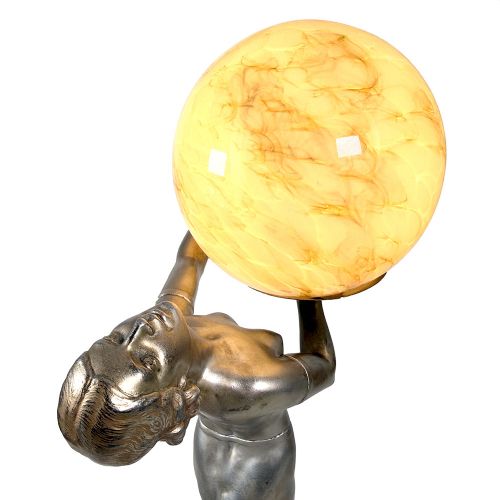 An Art Deco spelter table lamp featuring a silvered female figure holding up an amber glass globe shade on a circular onyx base. View VI