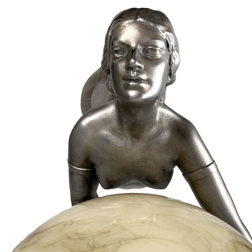 An Art Deco spelter table lamp featuring a silvered female figure holding up an amber glass globe shade on a circular onyx base. View VII