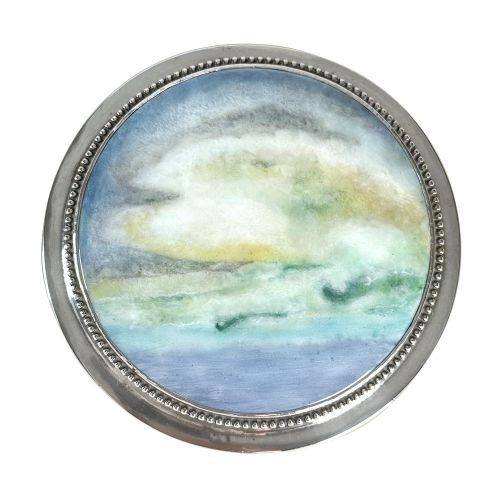 A circular Arts and Crafts sterling silver box featuring a hand-painted enamel landscape plaque inset on the lid with a beaded silver border. View II