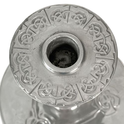 A pair of silver-tone pewter candlesticks featuring tapered cylindrical stems, flat wide sconces, and broad circular bases decorated with relief stylised plant motifs. View III