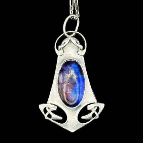 An Arts and Crafts sterling silver pendant featuring stylized Celtic knotwork and a central oval blue enamel cabochon suspended from a fine silver chain. View IV