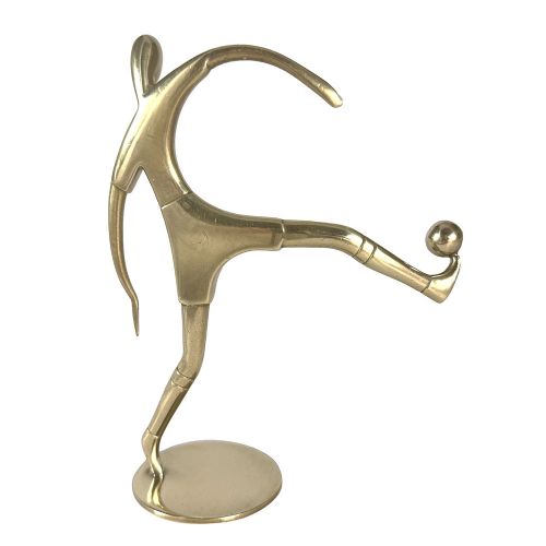 A stylised brass statuette depicting a footballer balancing a football on his foot set upon a circular base. View II