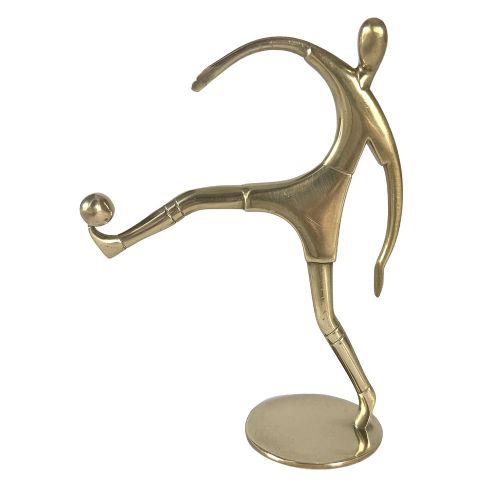 A stylised brass statuette depicting a footballer balancing a football on his foot set upon a circular base. View III