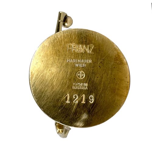A stylised brass statuette depicting a footballer balancing a football on his foot set upon a circular base. View V