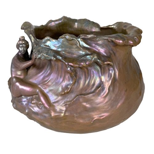 An Art Nouveau ceramic planter featuring an iridescent bronze and purple lustre glaze with a sculpted reclining female figure along undulating wave forms. View II