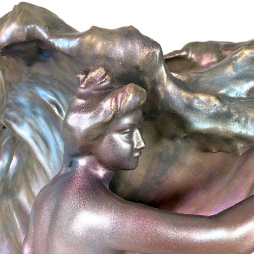 An Art Nouveau ceramic planter featuring an iridescent bronze and purple lustre glaze with a sculpted reclining female figure along undulating wave forms. View IV