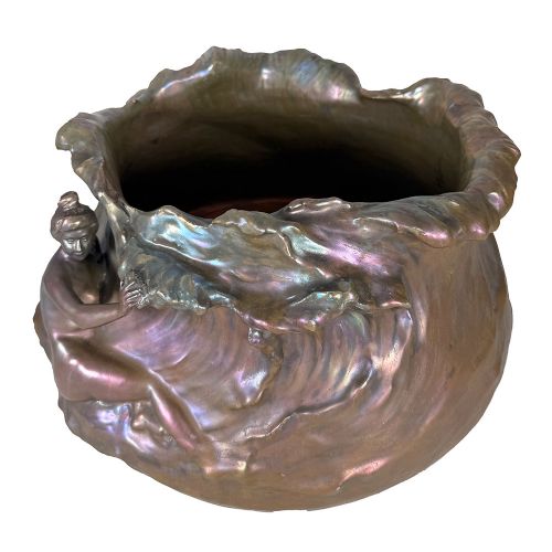 An Art Nouveau ceramic planter featuring an iridescent bronze and purple lustre glaze with a sculpted reclining female figure along undulating wave forms. View VI