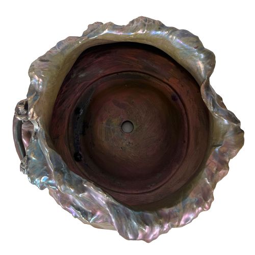 An Art Nouveau ceramic planter featuring an iridescent bronze and purple lustre glaze with a sculpted reclining female figure along undulating wave forms. View VII