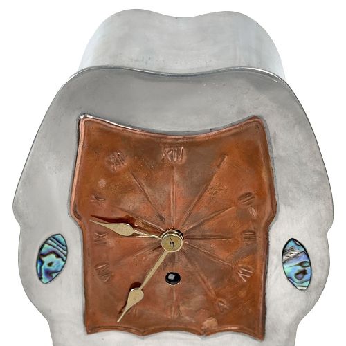 An Arts and Crafts pewter mantel clock featuring a square copper dial with Roman numerals and three iridescent abalone shell cabochon inlays. View III