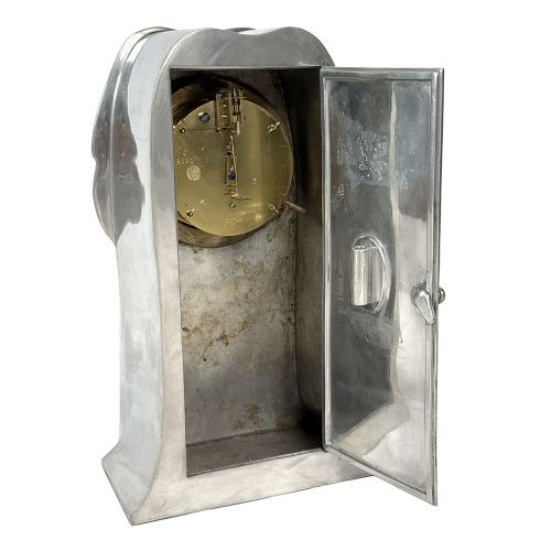 An Arts and Crafts pewter mantel clock featuring a square copper dial with Roman numerals and three iridescent abalone shell cabochon inlays. View VIII