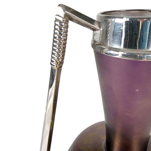 An Art Nouveau Secessionist purple iridescent glass vase held within a geometric silver-plated metal mount with high angular handles. View VI