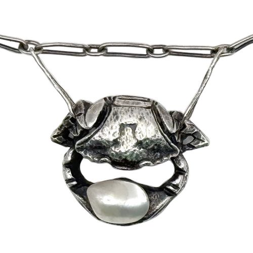 An Art Nouveau silver chain necklace featuring three crab motif drops, each holding an iridescent river pearl. View IV