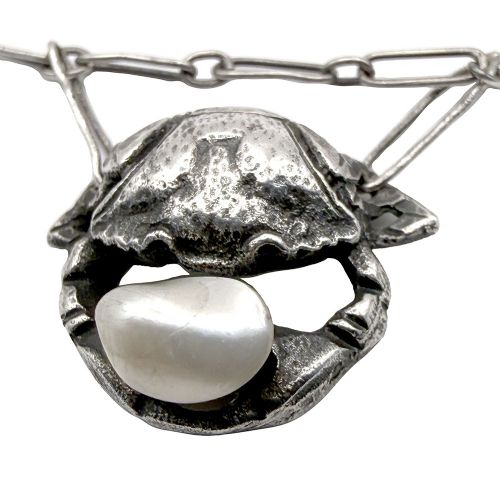 An Art Nouveau silver chain necklace featuring three crab motif drops, each holding an iridescent river pearl. View VI