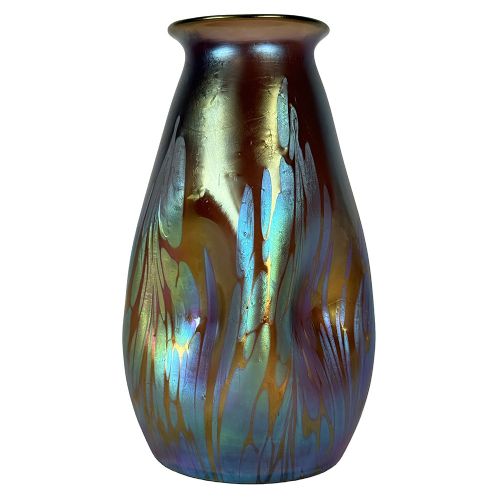 A baluster-shaped Art Nouveau iridescent glass vase featuring fluid metallic blue and gold drip trailing across a bronze-toned body. View II