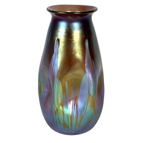 A baluster-shaped Art Nouveau iridescent glass vase featuring fluid metallic blue and gold drip trailing across a bronze-toned body. View III
