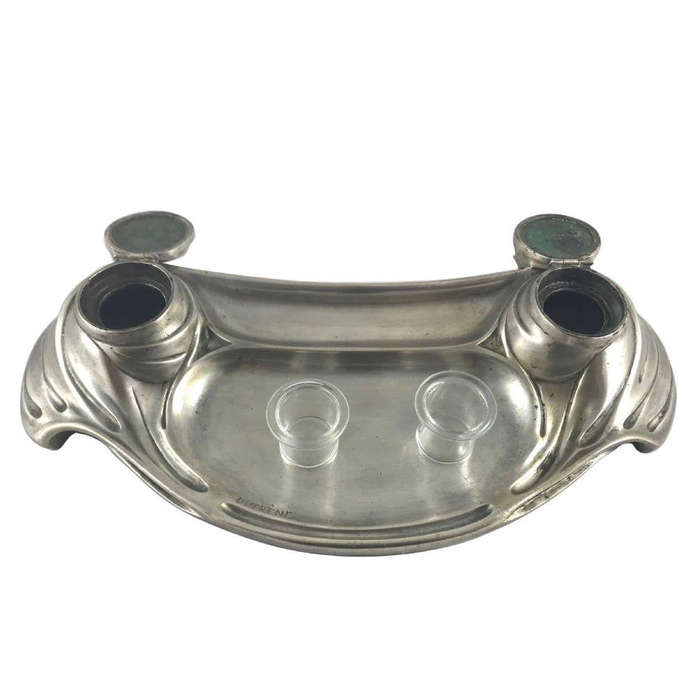 An Art Nouveau silvered bronze double inkwell featuring asymmetrical flowing curved trays and two raised hinged ink pots on either side. View III