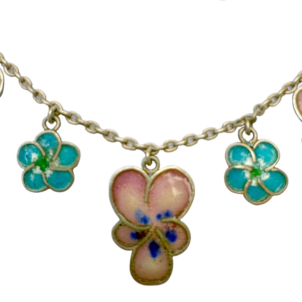 An antique silver necklace featuring dangling enamel pansy flower charms suspended from a delicate chain. View III