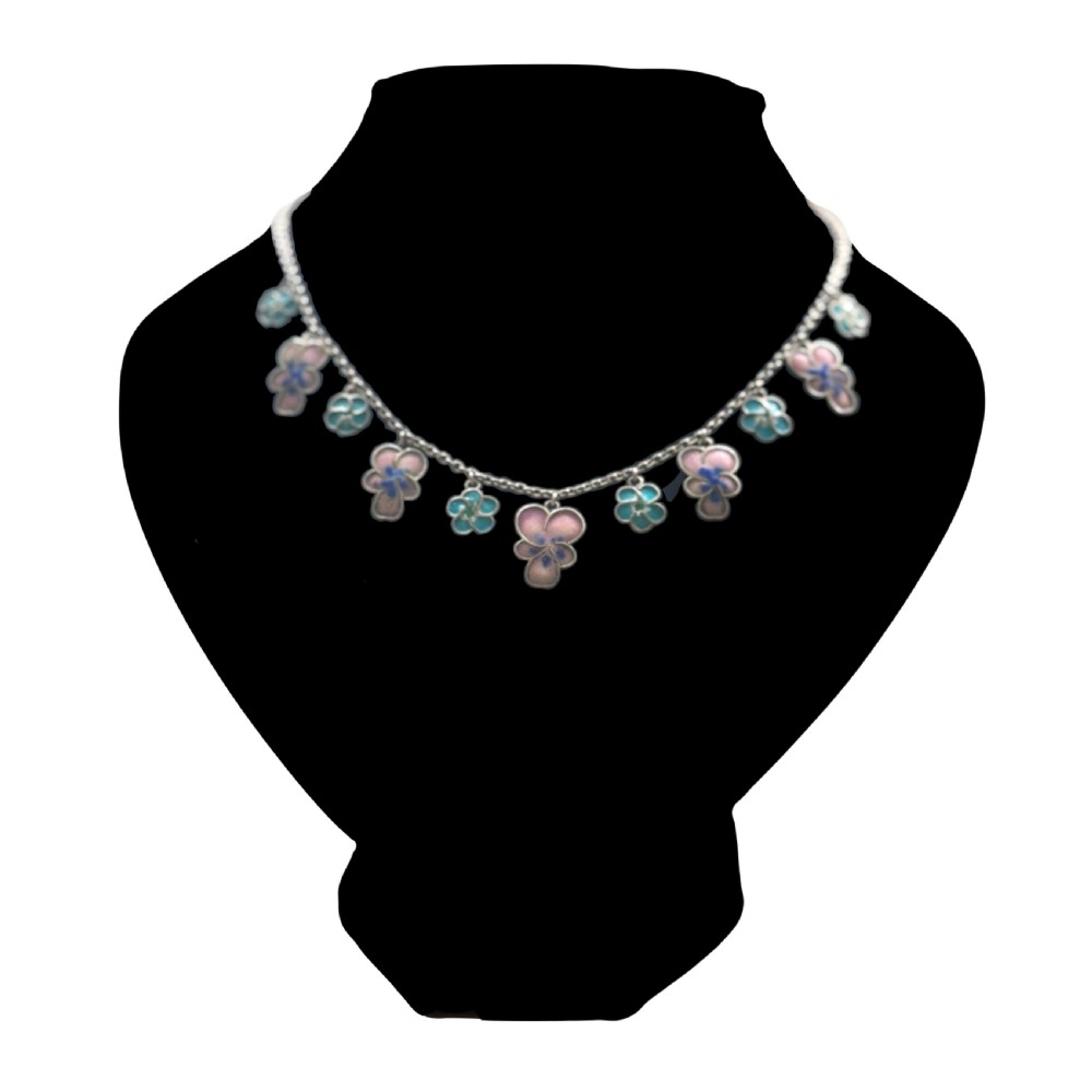 An antique silver necklace featuring dangling enamel pansy flower charms suspended from a delicate chain. View VI