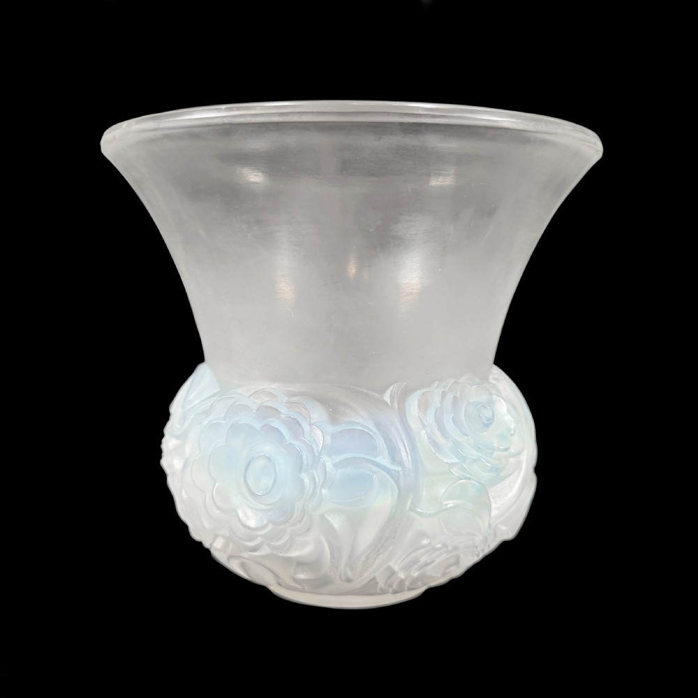 An Art Deco opalescent glass vase with a smooth flared upper rim and a rounded lower body decorated with moulded buttercup relief patterns.