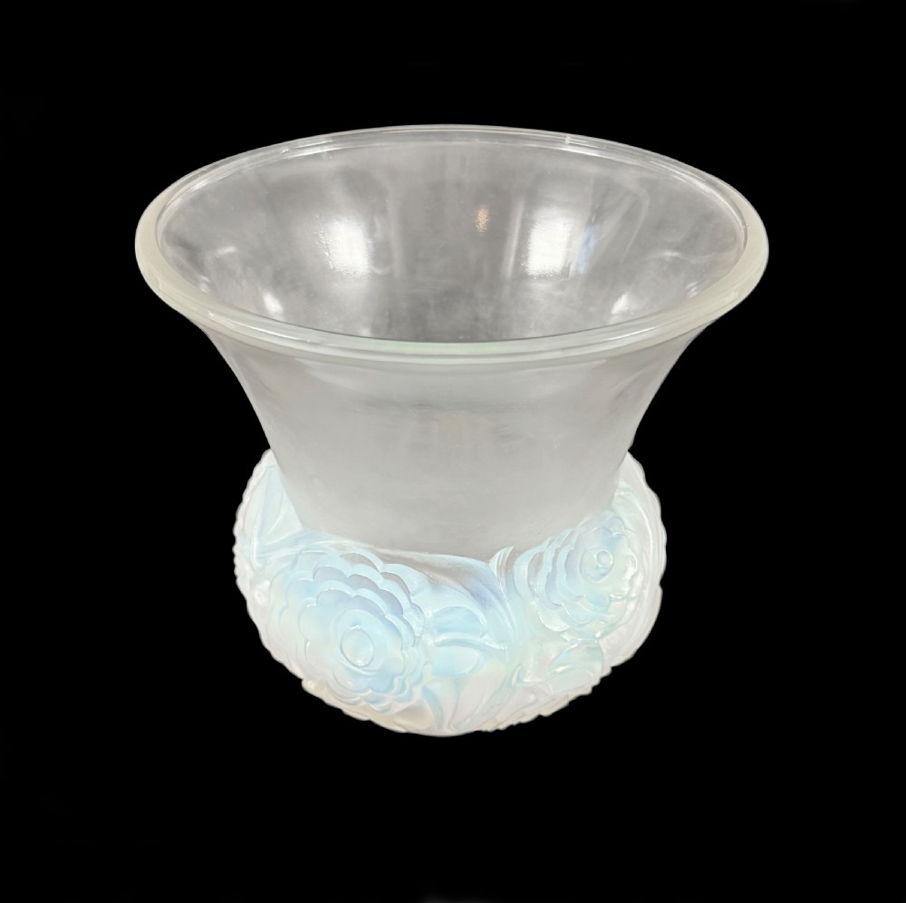 An Art Deco opalescent glass vase with a smooth flared upper rim and a rounded lower body decorated with moulded buttercup relief patterns. View II