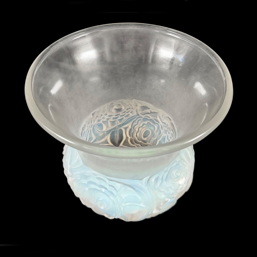 An Art Deco opalescent glass vase with a smooth flared upper rim and a rounded lower body decorated with moulded buttercup relief patterns. View III