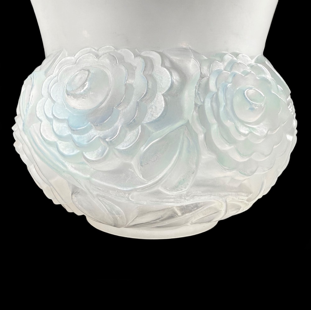 An Art Deco opalescent glass vase with a smooth flared upper rim and a rounded lower body decorated with moulded buttercup relief patterns. View IV