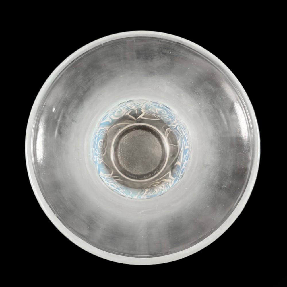 An Art Deco opalescent glass vase with a smooth flared upper rim and a rounded lower body decorated with moulded buttercup relief patterns. View V