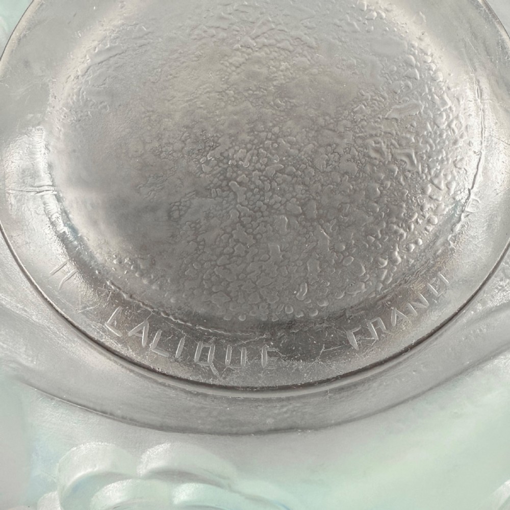 An Art Deco opalescent glass vase with a smooth flared upper rim and a rounded lower body decorated with moulded buttercup relief patterns. View VII