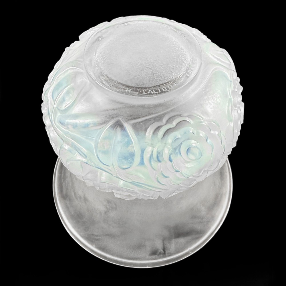 An Art Deco opalescent glass vase with a smooth flared upper rim and a rounded lower body decorated with moulded buttercup relief patterns. View VIII