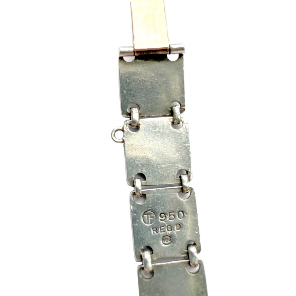 A German Jugendstil silver panel bracelet featuring linked rectangular segments inset with red and green enamelled geometric motifs. View III