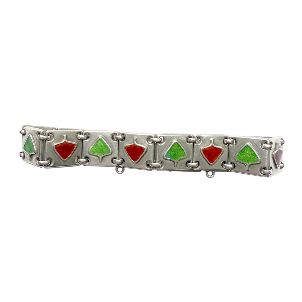 A German Jugendstil silver panel bracelet featuring linked rectangular segments inset with red and green enamelled geometric motifs. View V