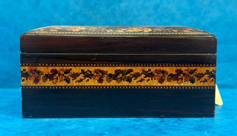 A square Victorian wooden box featuring a central floral mosaic inlay panel, detailed geometric mosaic borders, and a metal key. View II