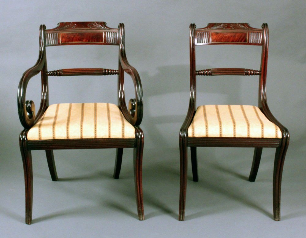 Six Regency mahogany sabre leg dining chairs