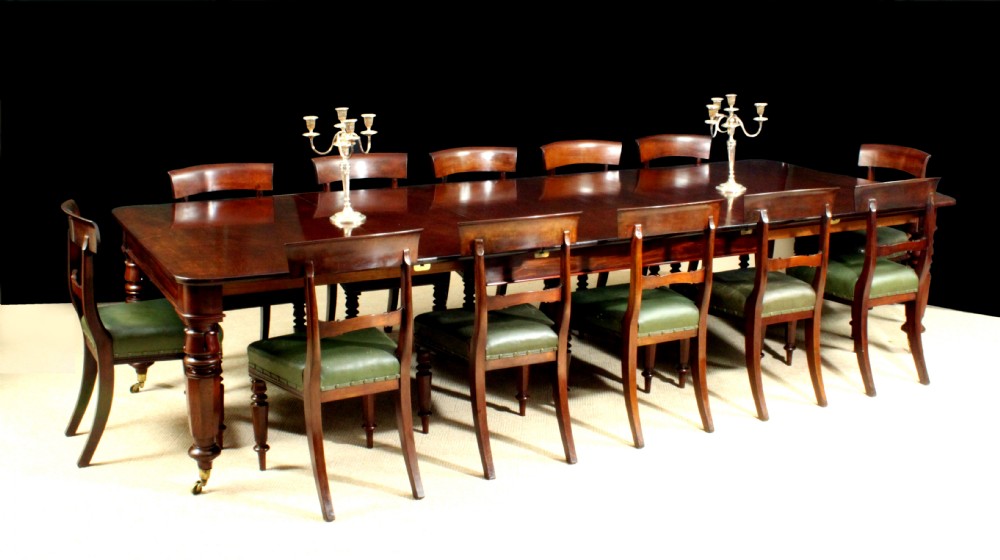 Antique dining table with matching set of twelve dining chairs