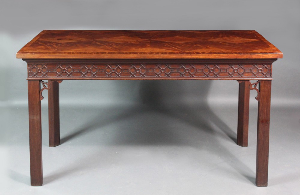 A dark mahogany rectangular Chippendale side table with a parquetry top, blind fretwork carved frieze, pierced corner brackets, and straight square legs. View II