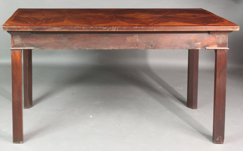 A dark mahogany rectangular Chippendale side table with a parquetry top, blind fretwork carved frieze, pierced corner brackets, and straight square legs. View VI
