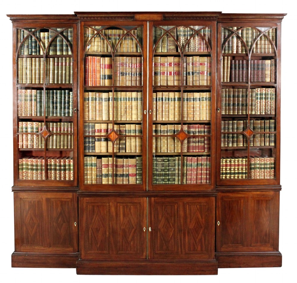 A large George III mahogany breakfront bookcase with glazed upper doors featuring Gothic astragal glazing bars and panelled lower cupboard doors.