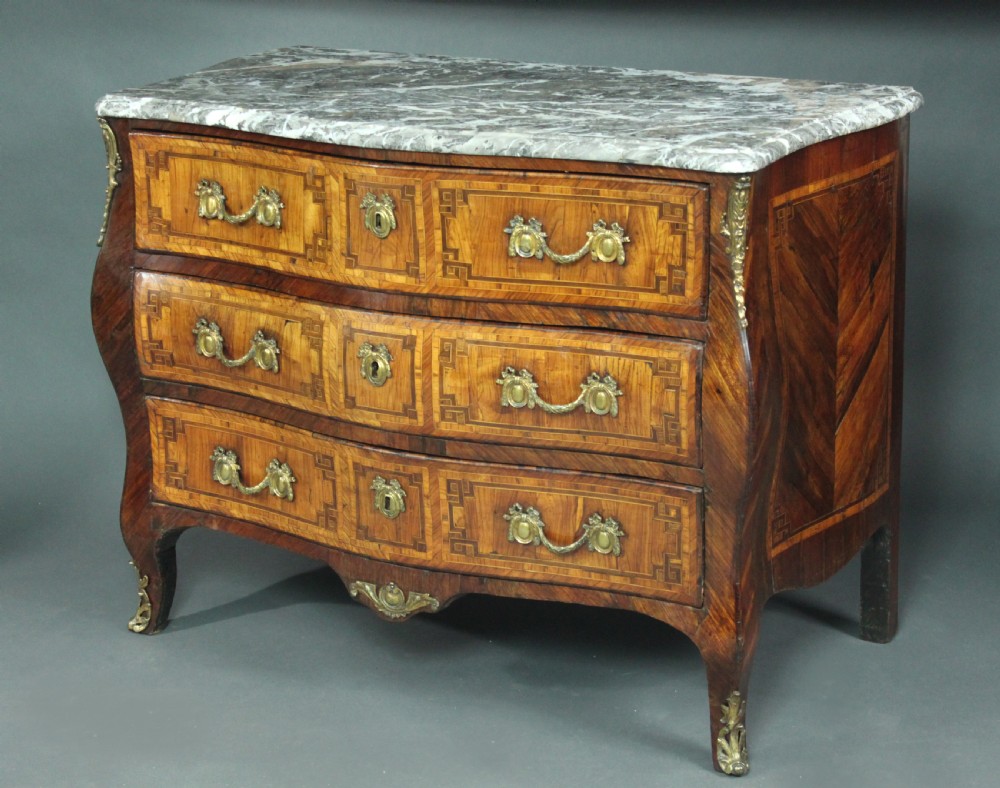 A Louis XV style kingwood commode featuring three drawers with geometric parquetry inlay, gilt bronze mounts, and a shaped grey marble top. View II